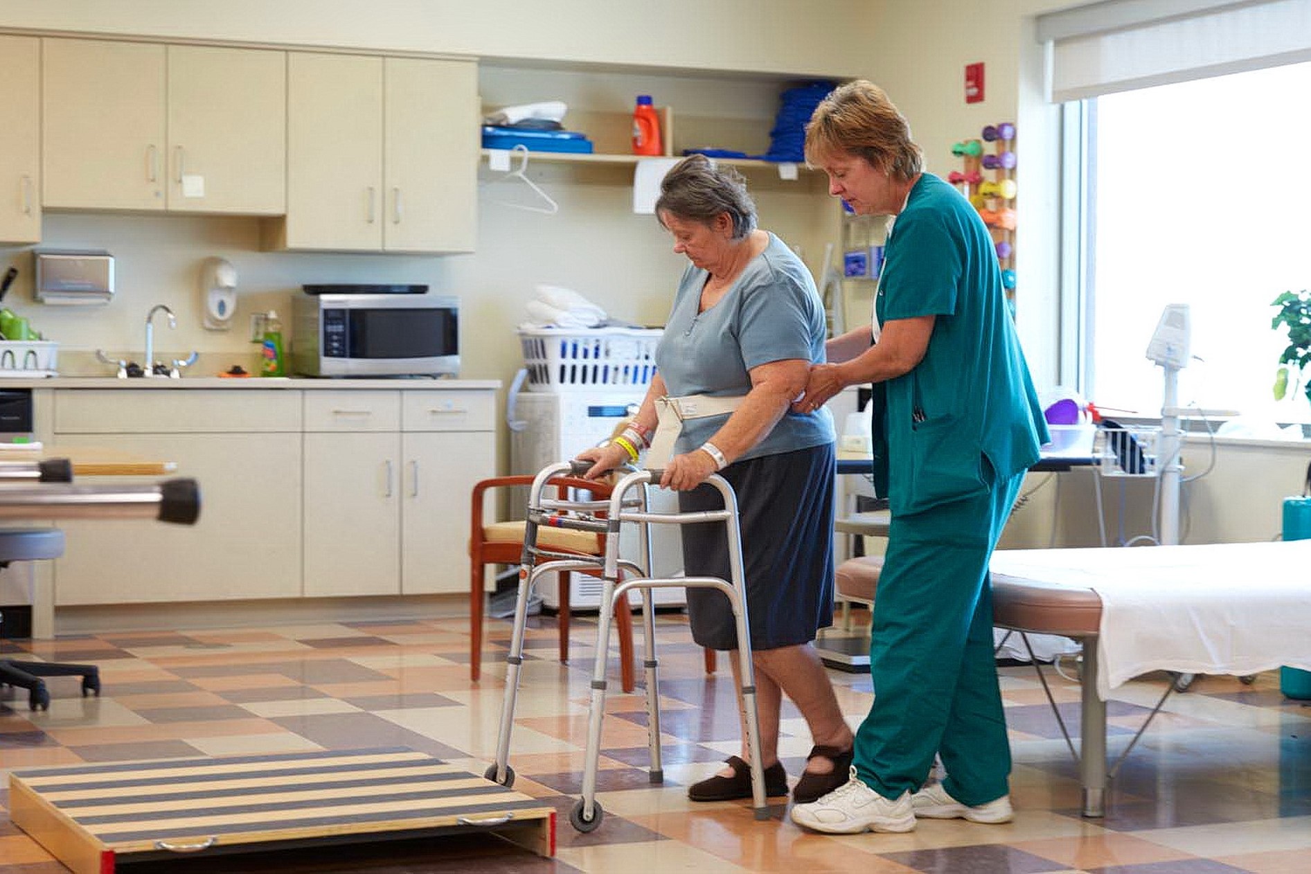 Occupational therapist helping a patient walk